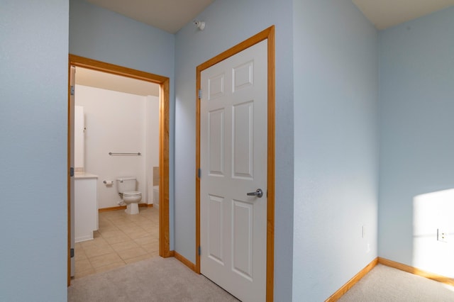 hallway with light carpet and baseboards