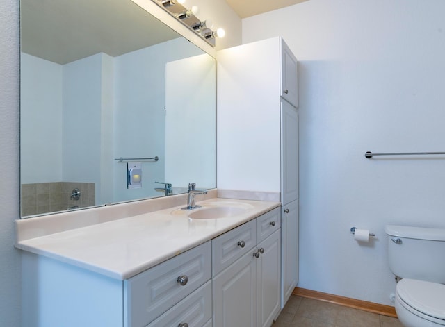 bathroom featuring tile patterned floors, toilet, vanity, and baseboards