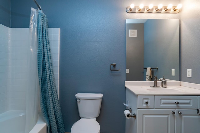 full bathroom with shower / tub combo with curtain, toilet, vanity, and a textured wall