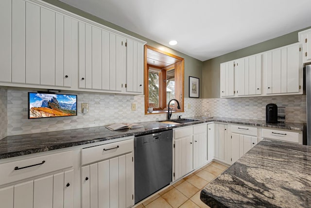 kitchen featuring a sink, backsplash, dark stone counters, light tile patterned floors, and dishwasher