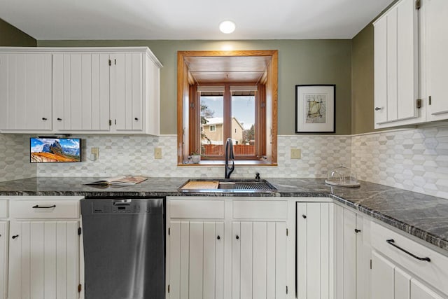 kitchen with decorative backsplash, white cabinets, dishwasher, and a sink