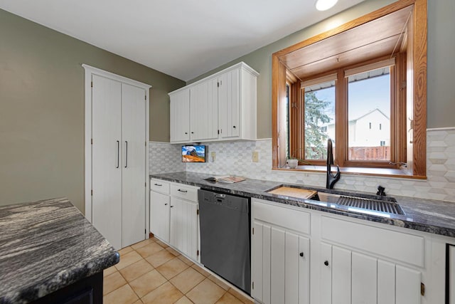 kitchen with light tile patterned floors, a sink, white cabinets, dishwasher, and tasteful backsplash