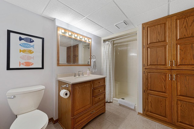 full bathroom featuring visible vents, toilet, a stall shower, a paneled ceiling, and vanity