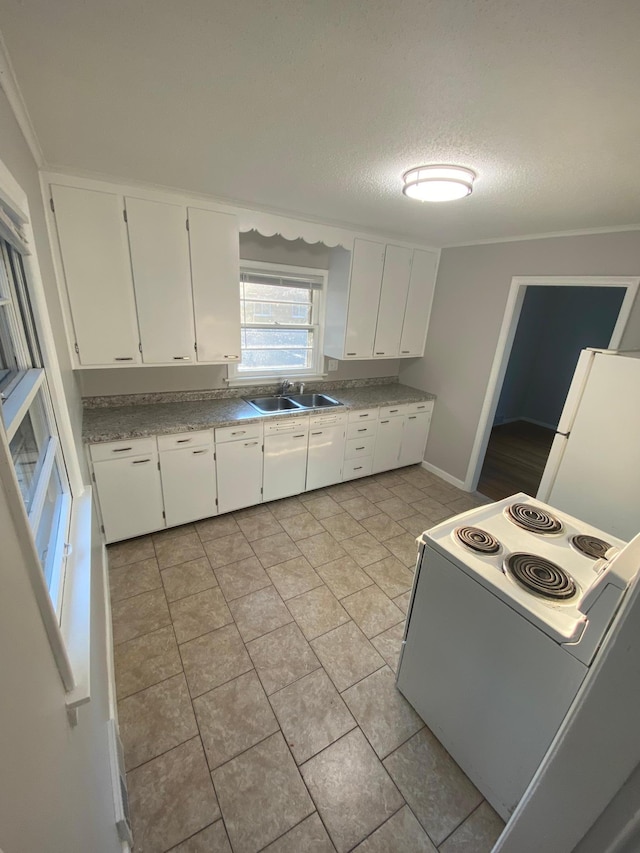 kitchen with white cabinetry, white appliances, a textured ceiling, and a sink