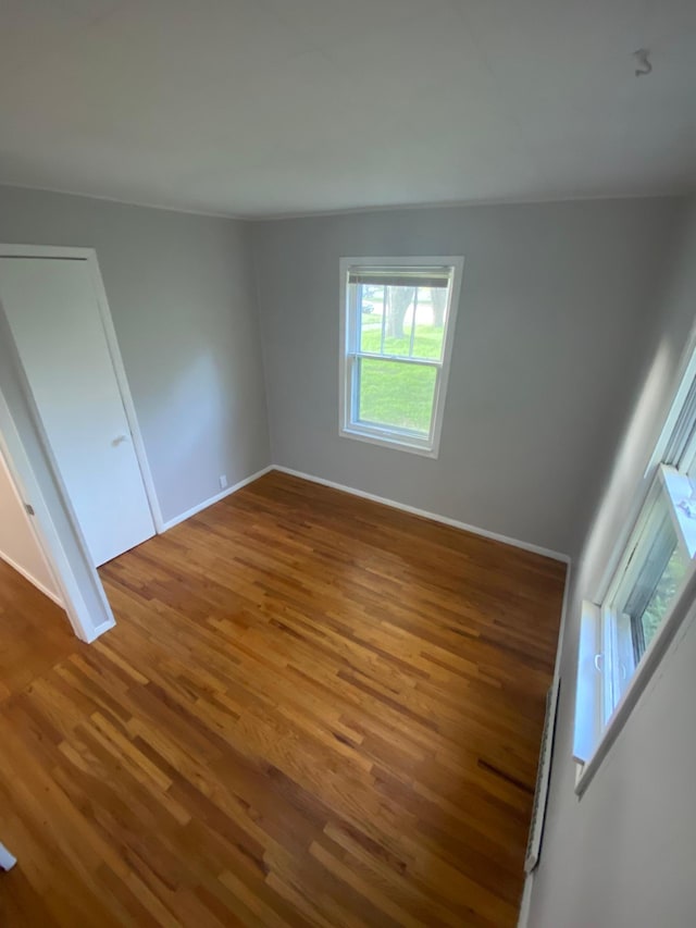 unfurnished bedroom featuring baseboards and wood finished floors