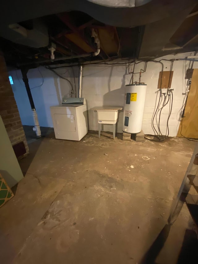 unfinished basement featuring washer / clothes dryer and water heater