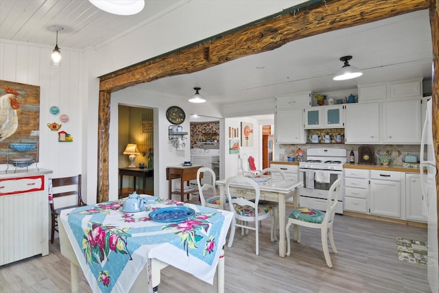 dining room featuring radiator heating unit, washer / clothes dryer, and light wood-type flooring