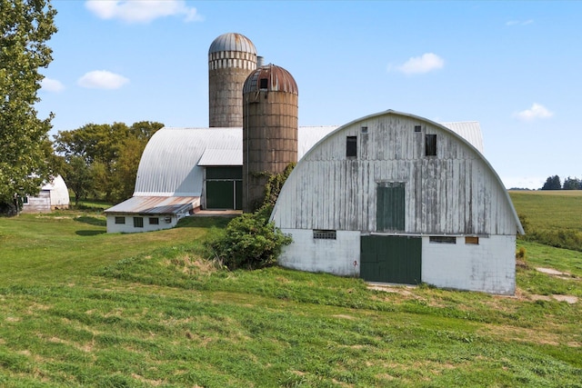 view of barn with a lawn