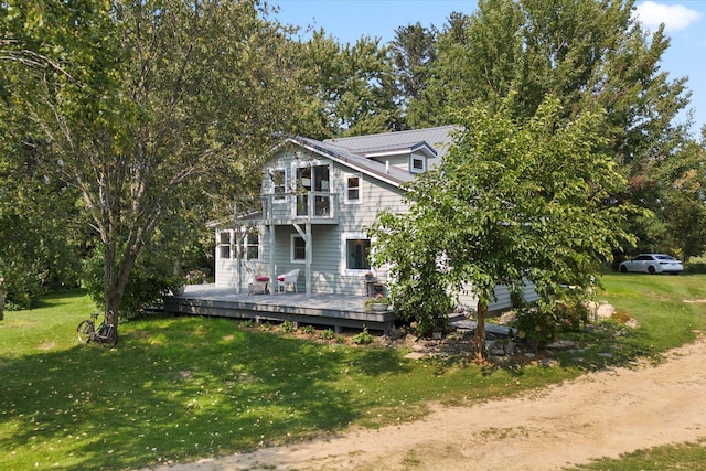 view of front of home with a front yard and a wooden deck