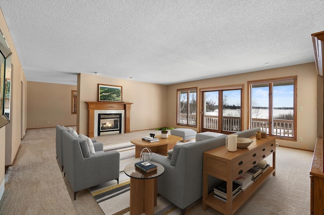 living area with a healthy amount of sunlight, light colored carpet, and a tile fireplace