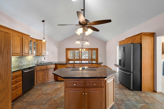 kitchen featuring a peninsula, stainless steel fridge with ice dispenser, a sink, dishwasher, and black electric stovetop