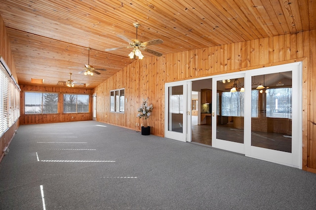 unfurnished sunroom with vaulted ceiling, wood ceiling, and french doors