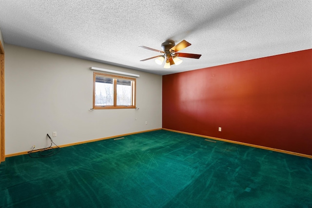 carpeted empty room featuring visible vents, a textured ceiling, baseboards, and a ceiling fan