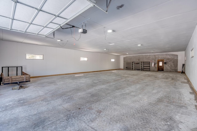 garage with a garage door opener and baseboards