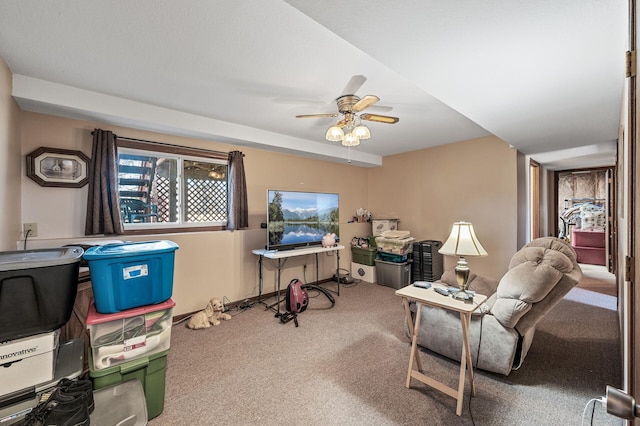 living room featuring carpet flooring and ceiling fan