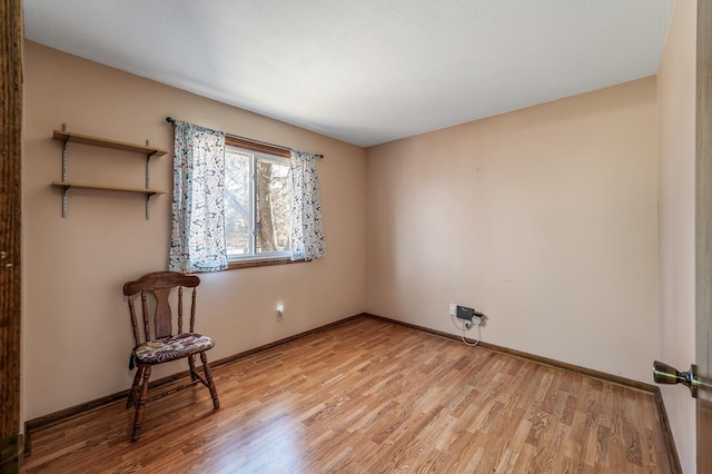 unfurnished room featuring light wood-style floors and baseboards