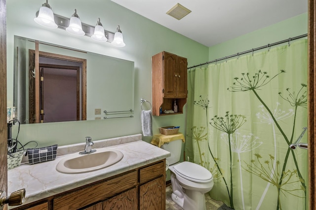 bathroom featuring vanity, toilet, a shower with curtain, and visible vents