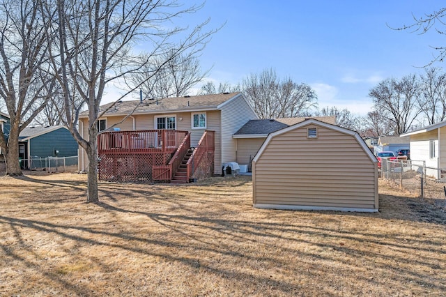 back of property featuring a yard, stairway, a wooden deck, and fence