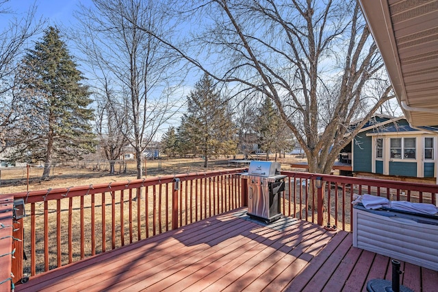 deck featuring area for grilling and fence