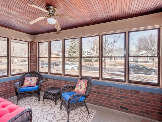 sunroom / solarium with wooden ceiling and a ceiling fan