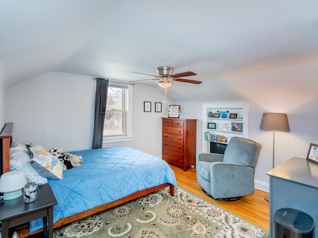 bedroom featuring vaulted ceiling, a ceiling fan, and wood finished floors