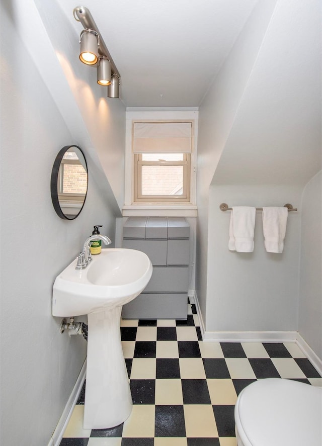 bathroom featuring tile patterned floors, toilet, and baseboards