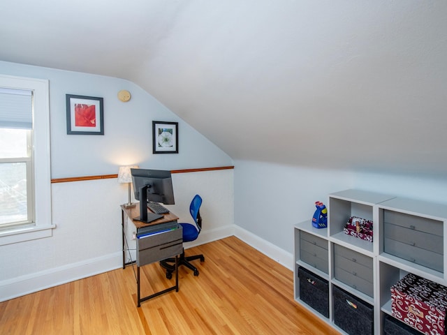 home office with lofted ceiling, wood finished floors, and baseboards