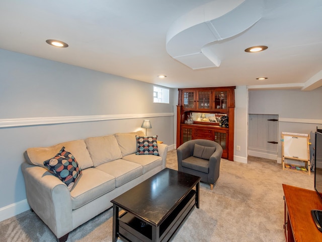 living room with recessed lighting, light colored carpet, and baseboards