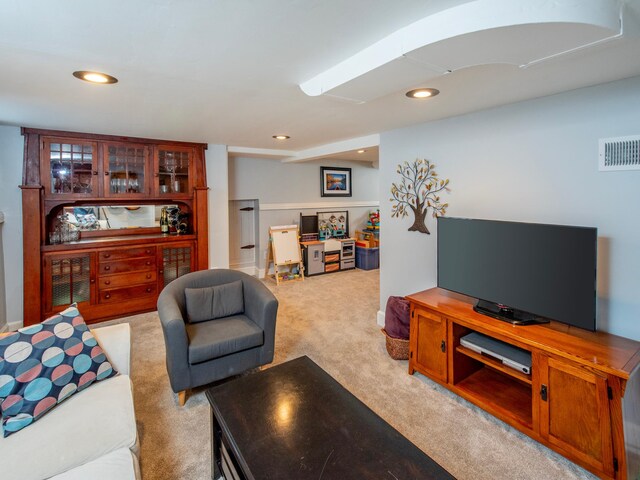 living room with recessed lighting, light colored carpet, and visible vents