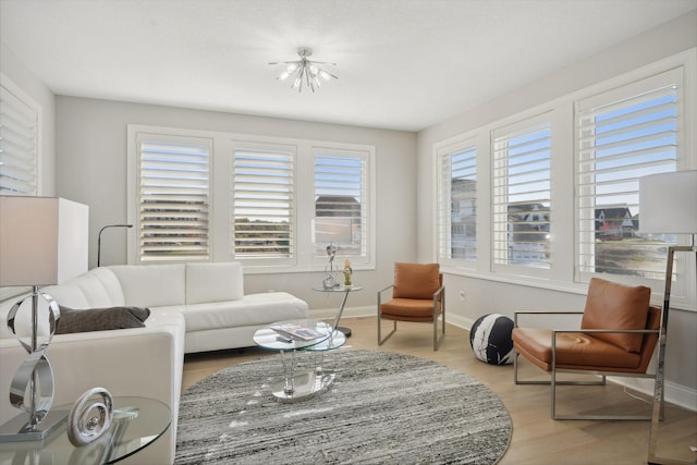 living room featuring baseboards and light wood-type flooring