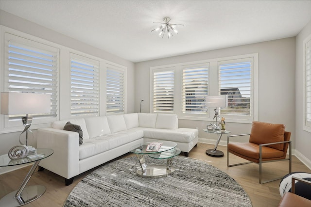 living area with baseboards and light wood-style floors