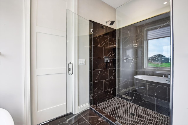 full bathroom with a tile shower