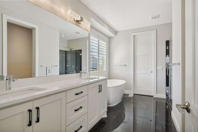 bathroom with a soaking tub, a shower stall, visible vents, and a sink