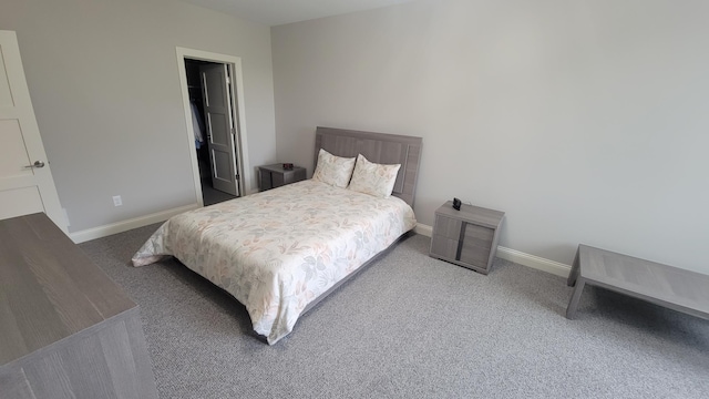 bedroom with baseboards and carpet