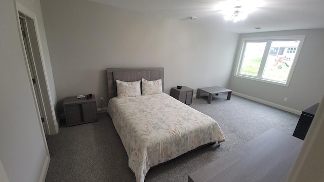 bedroom featuring baseboards and carpet flooring