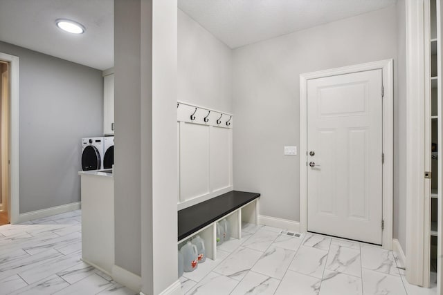 mudroom with baseboards, marble finish floor, and washing machine and clothes dryer