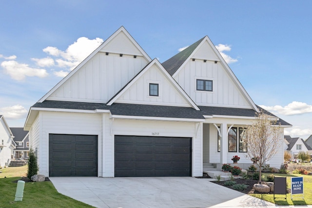 modern inspired farmhouse featuring concrete driveway, an attached garage, board and batten siding, and a shingled roof