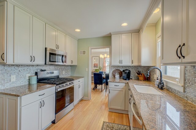 5920 Colfax Ave S, Minneapolis, MN 55419 - kitchen featuring a sink, decorative backsplash, appliances with stainless steel finishes, and a wealth of natural light