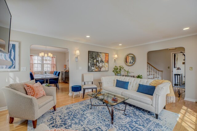 5920 Colfax Ave S, Minneapolis, MN 55419 - living area featuring an inviting chandelier, arched walkways, light wood-style flooring, and ornamental molding