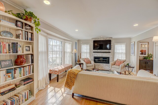 5920 Colfax Ave S, Minneapolis, MN 55419 - living room featuring recessed lighting, ornamental molding, a stone fireplace, and light wood-style flooring