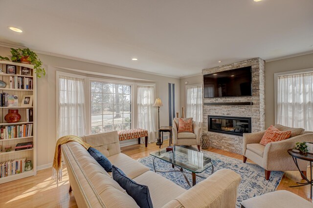 5920 Colfax Ave S, Minneapolis, MN 55419 - living area featuring light wood finished floors, a fireplace, recessed lighting, baseboards, and ornamental molding