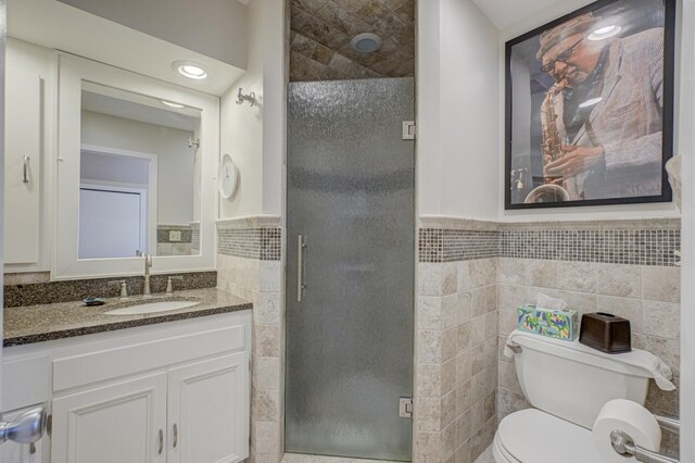 5920 Colfax Ave S, Minneapolis, MN 55419 - full bath with wainscoting, vanity, toilet, tile walls, and a shower stall