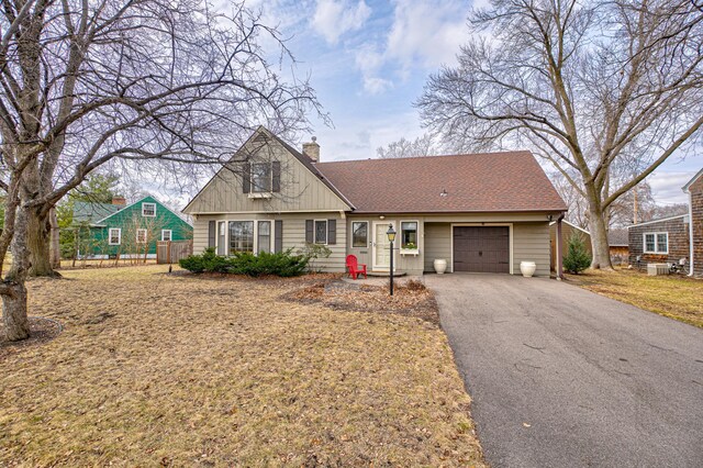 5920 Colfax Ave S, Minneapolis, MN 55419 - traditional home with fence, an attached garage, a chimney, and driveway