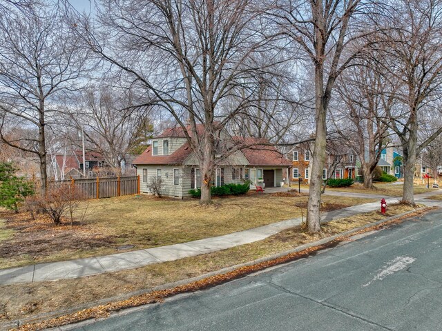 5920 Colfax Ave S, Minneapolis, MN 55419 - traditional home with a porch, fence, a residential view, and a front lawn