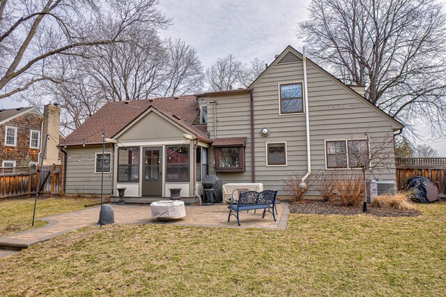 5920 Colfax Ave S, Minneapolis, MN 55419 - rear view of property with a patio, a fenced backyard, a sunroom, a shingled roof, and a lawn