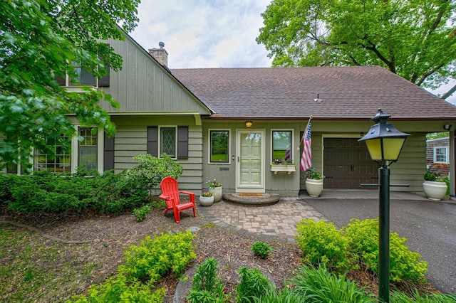 5920 Colfax Ave S, Minneapolis, MN 55419 - view of front of home with a garage, a chimney, and a shingled roof