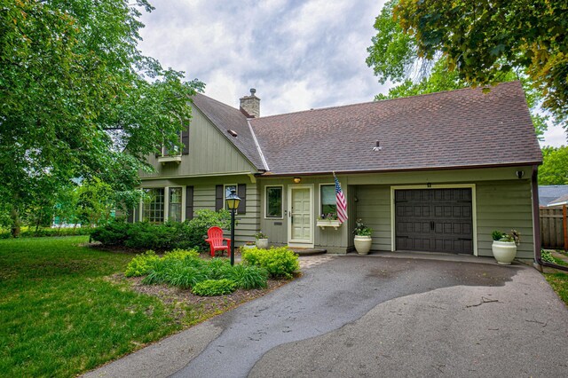 5920 Colfax Ave S, Minneapolis, MN 55419 - view of front of house featuring a garage, a chimney, asphalt driveway, roof with shingles, and a front lawn
