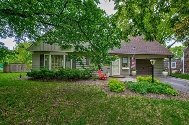 5920 Colfax Ave S, Minneapolis, MN 55419 - view of front of home with an attached garage, asphalt driveway, and roof with shingles