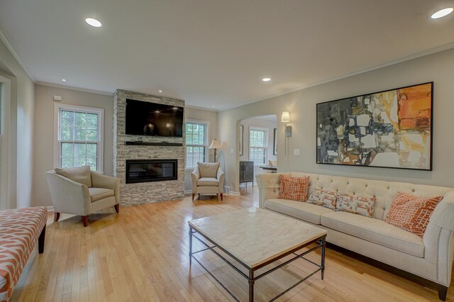 5920 Colfax Ave S, Minneapolis, MN 55419 - living area featuring ornamental molding, arched walkways, healthy amount of natural light, light wood finished floors, and a fireplace
