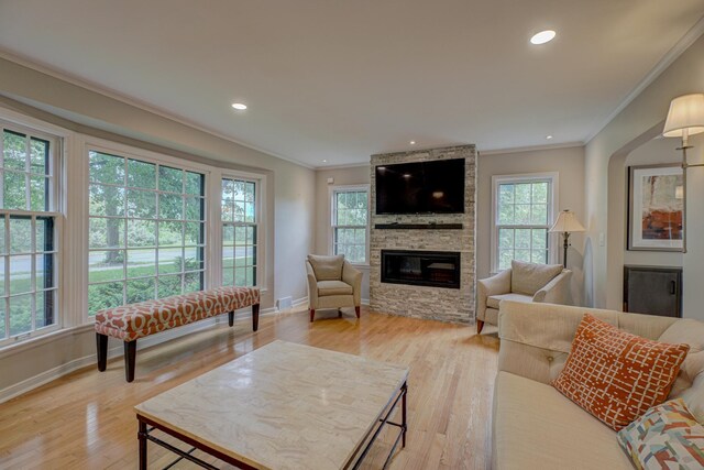 5920 Colfax Ave S, Minneapolis, MN 55419 - living room featuring ornamental molding, baseboards, light wood-style floors, a stone fireplace, and recessed lighting